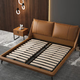 Ardelle Bed in caramel vegan leather with padded headboard and minimalist design in modern bedroom setting.