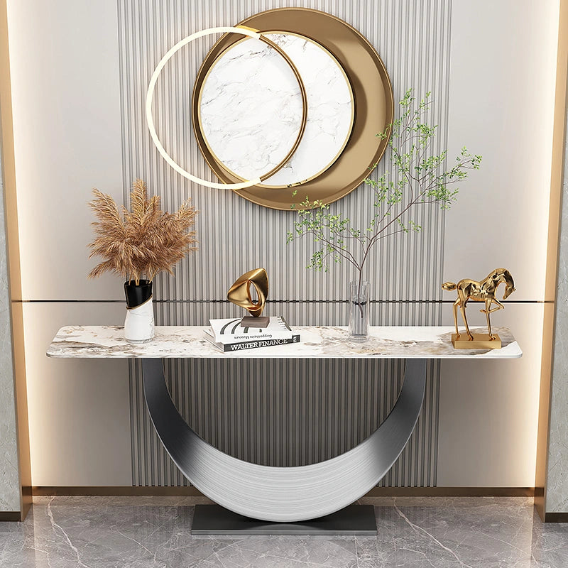Celestia Console Table featuring a half-moon stainless steel pedestal and natural sintered stone surface in a modern luxury setting.