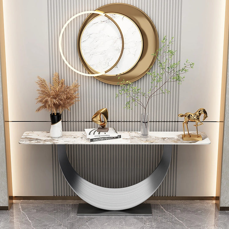 Celestia Console Table featuring a half-moon stainless steel pedestal and natural sintered stone surface in a modern luxury setting.