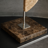 Roche Marble Sculpture showcases a polished marble base with chrome support, highlighting modern decorative accents.