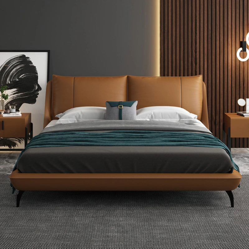 Ardelle Bed in caramel vegan leather with curved headboard and modern decor accents.